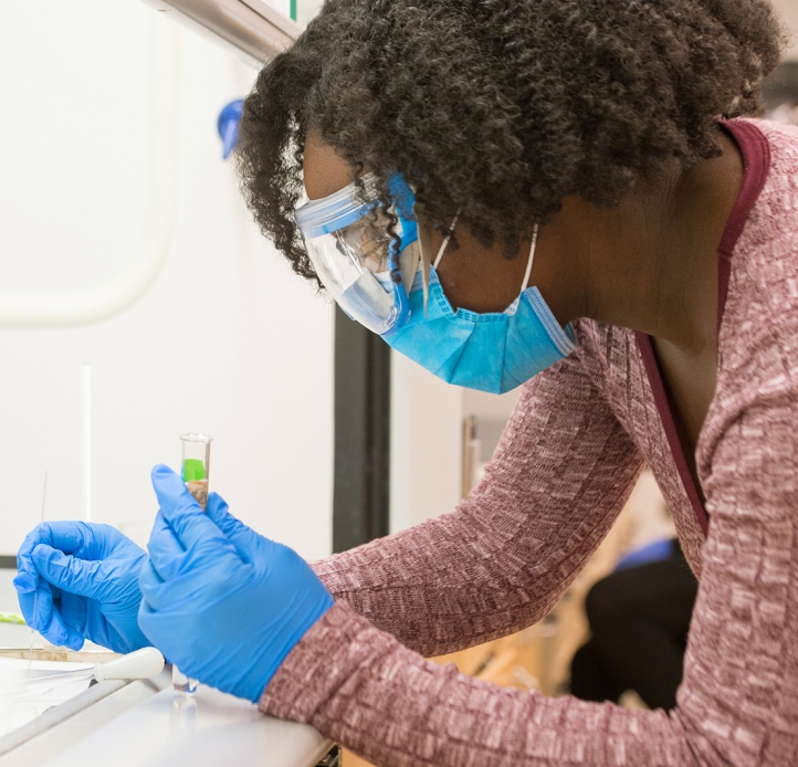 Student in organic chemistry lab holding a test tube.